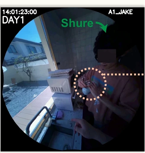 Day 1, 14:01. Jake holds a blue hand mixer at the sink while Shure reaches in to help.